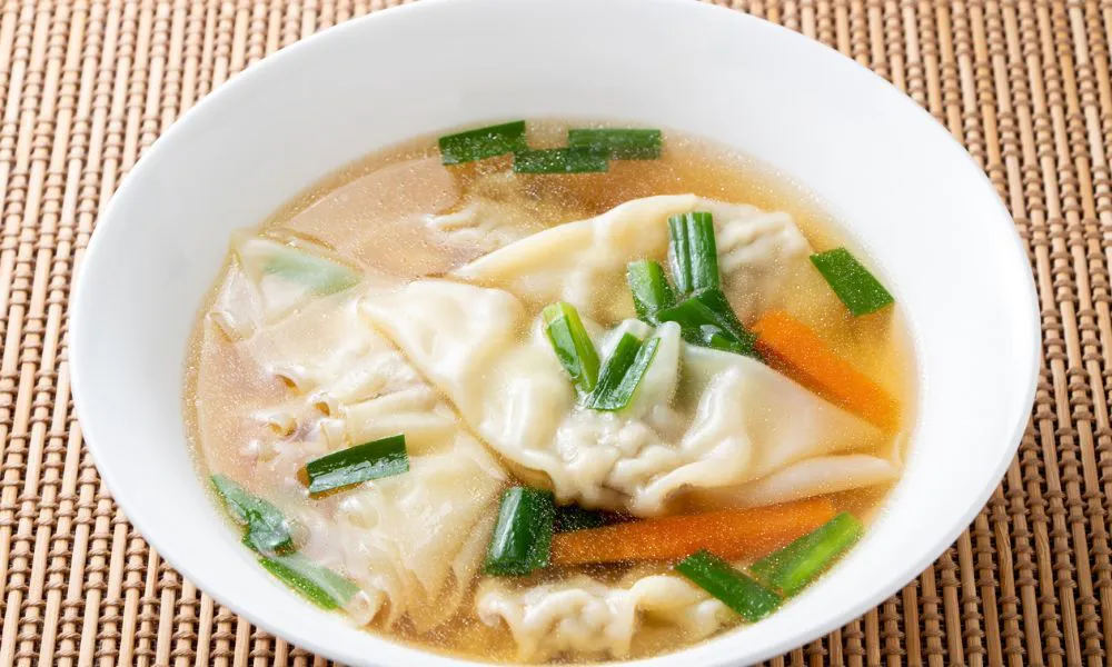 Wonton soup with dumplings, scallions, and carrots in clear broth at Oriental Express, a Chinese Restaurant in Denville