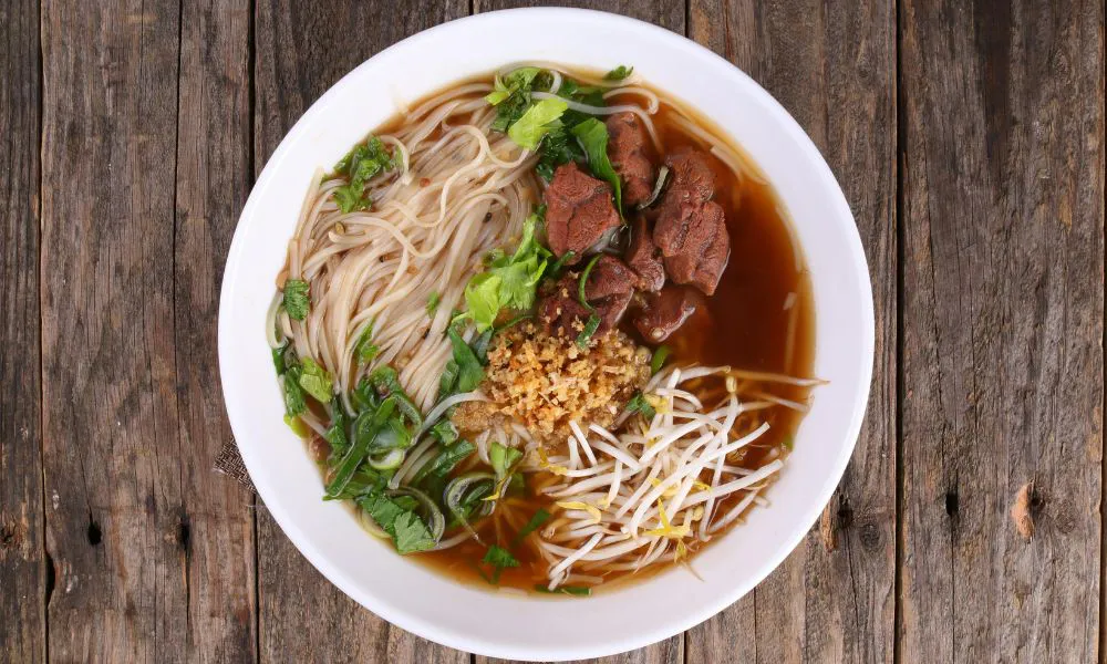 Beef noodle soup with bean sprouts, herbs, and garlic topping at Oriental Express, a Chinese Restaurant in Denville
